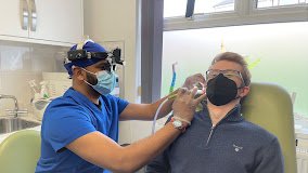Armaj performing microsuction earwax removal at BestHear Swansea